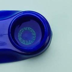 a blue frisbee is sitting on a table