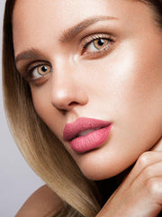 a girl with a toothbrush in her mouth