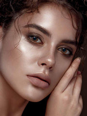 a close up of a young child holding a cell phone