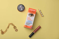 a wooden table topped with a cell phone and a pair of scissors