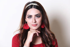 a woman in a red dress talking on a cell phone