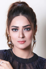 a woman wearing glasses and a black shirt