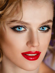 a close up of a child brushing her teeth