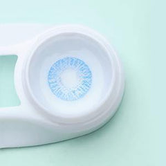 a close up of a blue and white frisbee on a table