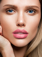 a young girl holding a toothbrush in her mouth