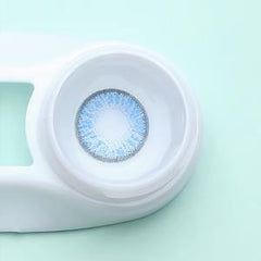 a close up of a toilet with a blue seat