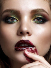 a close up of a child eating a doughnut