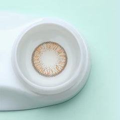 a close up of a cup on a white toilet