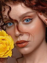 a woman wearing glasses eating a banana